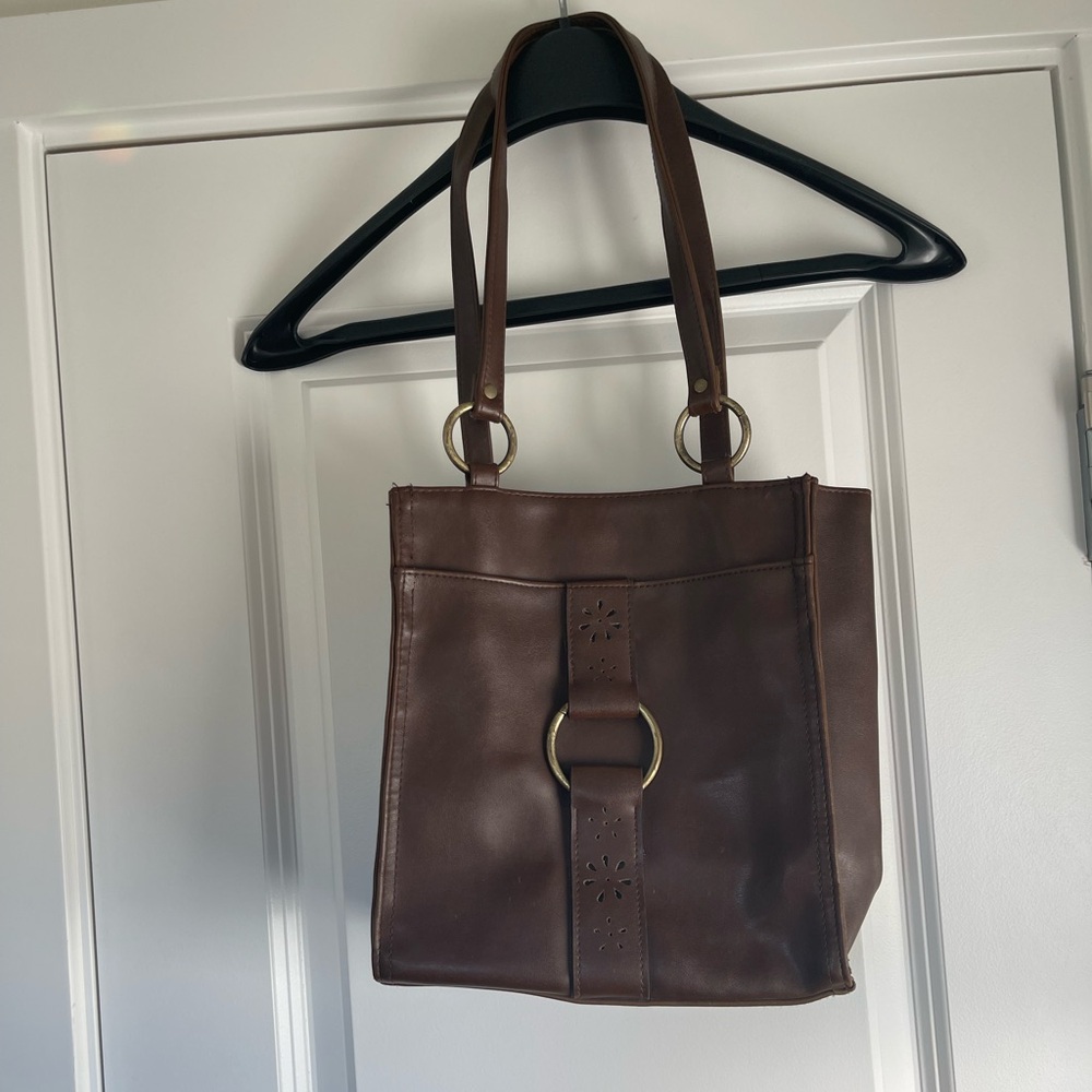 Brown leather square bucket purse with gold hardware and floral cutouts